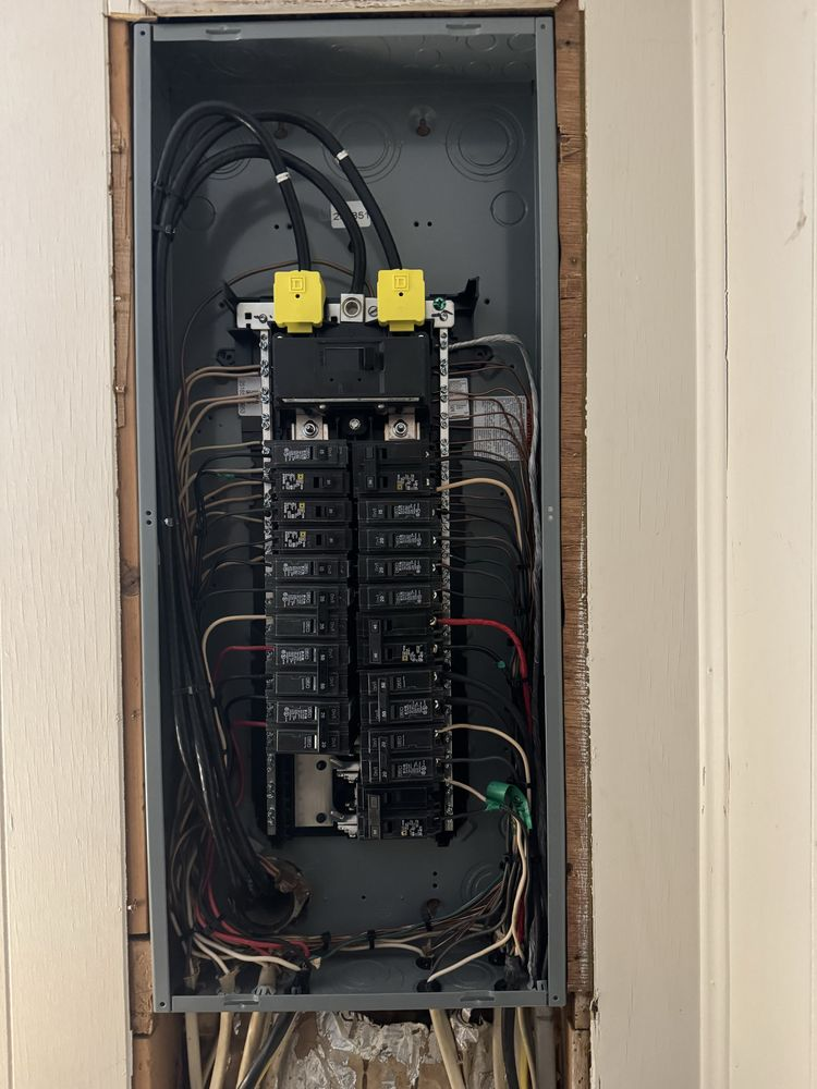 Open residential breaker panel with neatly organized circuit wiring