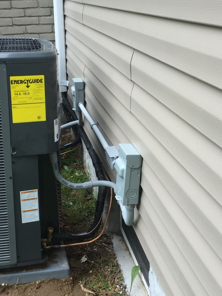 Exterior HVAC condenser with new electrical disconnect and conduit