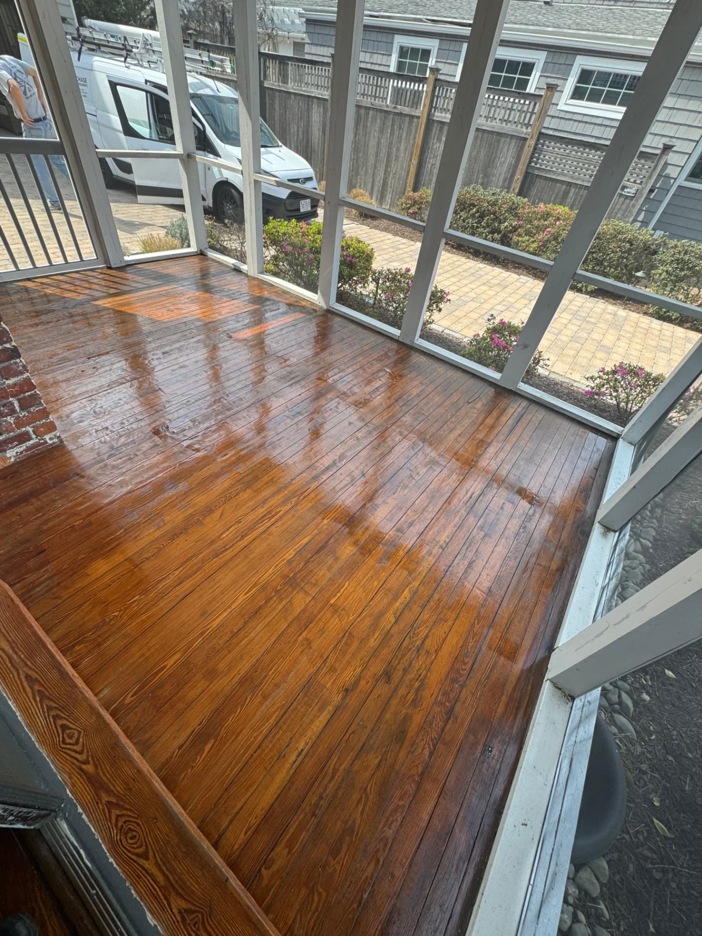 Freshly refinished tongue and groove porch flooring with glossy stain